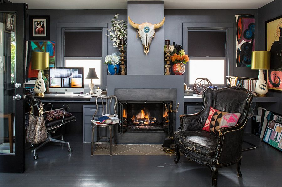 Stylish living space featuring a central fireplace with eclectic decor, including a black armchair, desk area, and wall-mounted skull.